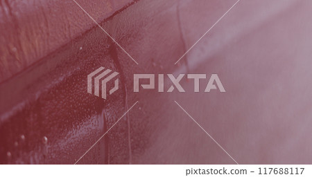 Closeup red car wash spraying degreaser on paint 117688117
