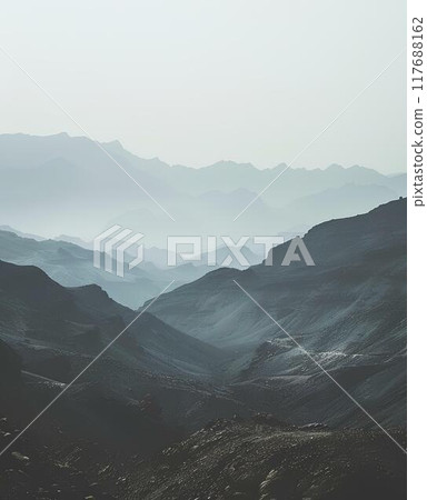vintage moody minimalist landscape of the arabian mountains, muted colors, soft tones, foggy 117688162