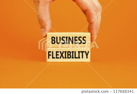 Business flexibility symbol. Concept words Business flexibility on beautiful wooden block. Beautiful orange paper background. Businessman hand. Business flexibility concept. Copy space. 117688341