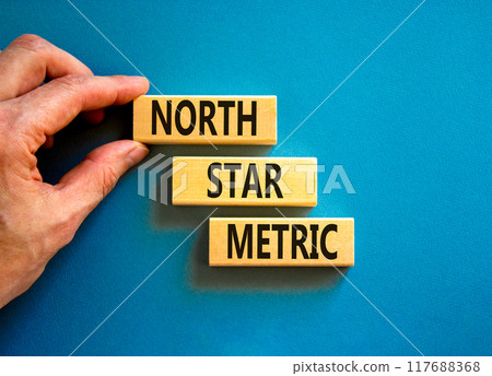 North star metric symbol. Concept words North star metric on wooden blocks on a beautiful blue table blue background. Businessman hand. Business finacial and north star metric concept. Copy space. North star metric symbol. Concept words North star metric on wooden blocks on a beautiful blue table blue background. Businessman hand. Business finacial and north star metric concept. Copy space. 117688368