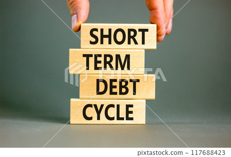 Short term debt cycle symbol. Concept words Short term debt cycle on beautiful wooden block. Beautiful grey table grey background. Businessman hand. Business Short term debt cycle concept. Copy space. 117688423