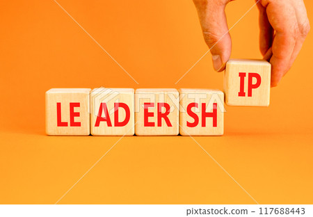 Leadership symbol. Concept word Leadership on beautiful wooden blocks. Beautiful orange background. Businessman hand. Business leadership concept. Copy space. Leadership symbol. Concept word Leadership on beautiful wooden blocks. Beautiful orange background. Businessman hand. Business leadership concept. Copy space. 117688443