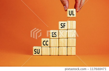 Successful symbol. Concept word Successful on beautiful wooden cubes. Beautiful orange background. Businessman hand. Business successful concept. Copy space. 117688471