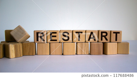 Concept word 'restart' on cubes on a beautiful wooden table. White background. Business concept. Concept word 'restart' on cubes on a beautiful wooden table. White background. Business concept. 117688486