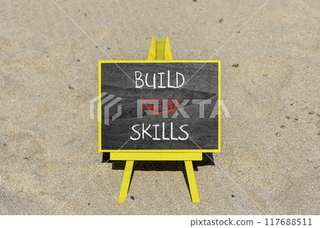 Build new skills symbol. Concept word Build new skills on beautiful black chalk blackboard. Sand beach. Beautiful sand beach background. Business, education build new skills concept. Copy space. Build new skills symbol. Concept word Build new skills on beautiful black chalk blackboard. Sand beach. Beautiful sand beach background. Business, education build new skills concept. Copy space. 117688511