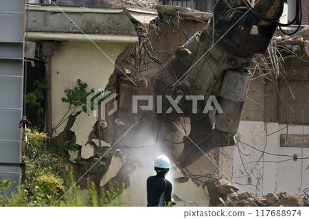 Construction site: A factory being demolished by heavy machinery 117688974