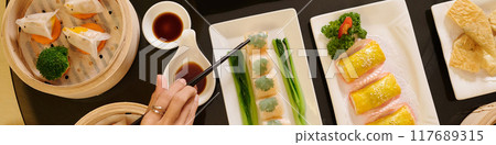 Woman Eating Rolls With Soy Sauce 117689315