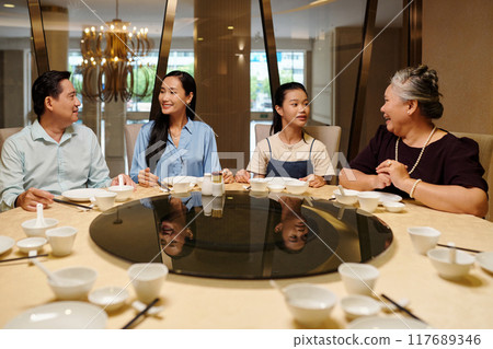 Asian Family Sitting In The Restaurant Asian Family Sitting In The Restaurant 117689346