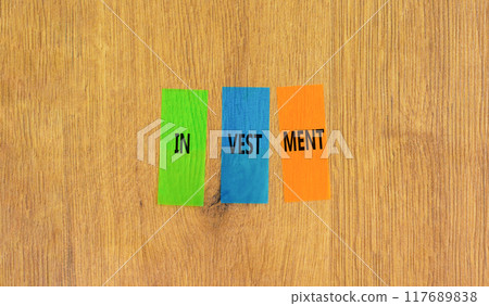Investment symbol. Concept word Investment on beautiful colored paper. Beautiful wooden background. Business investment concept. Copy space. Investment symbol. Concept word Investment on beautiful colored paper. Beautiful wooden background. Business investment concept. Copy space. 117689838
