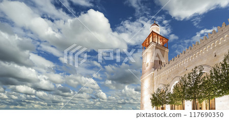 King Hussein Bin Talal mosque in Amman (at night), Jordan. Against the background of a beautiful sky with clouds King Hussein Bin Talal mosque in Amman (at night), Jordan. Against the background of a beautiful sky with clouds 117690350