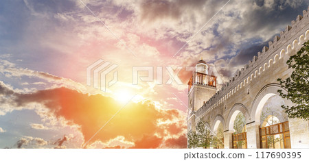 King Hussein Bin Talal mosque in Amman (at night), Jordan. Against the background of a beautiful sky with clouds King Hussein Bin Talal mosque in Amman (at night), Jordan. Against the background of a beautiful sky with clouds 117690395
