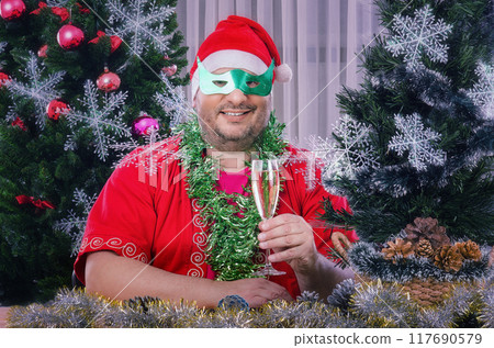 Christmas Incognito: Chubby-Cheeked Merrymaker Blends Tradition and Whimsy in Masked Holiday Celebration. Christmas Incognito: Chubby-Cheeked Merrymaker Blends Tradition and Whimsy in Masked Holiday Celebration. 117690579
