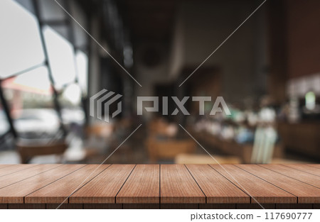 Empty wooden table top with lights bokeh on blur restaurant background. Empty wooden table top with lights bokeh on blur restaurant background. 117690777