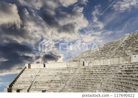 Roman Theatre in Amman, Jordan -- theatre was built the reign of Antonius Pius (138-161 CE), the large and steeply raked structure could seat about 6000 people. Against the sky with clouds Roman Theatre in Amman, Jordan -- theatre was built the reign of Antonius Pius (138-161 CE), the large and steeply raked structure could seat about 6000 people. Against the sky with clouds 117690822