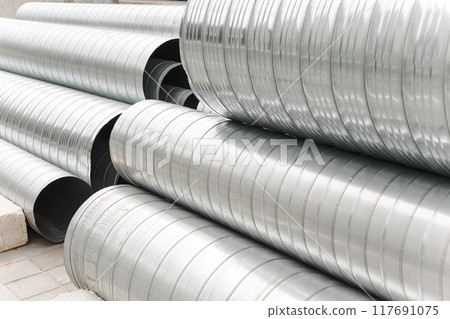 Metal profile pipes of different sizes are located in the warehouse of metal products. Metal profile pipes of different sizes are located in the warehouse of metal products. 117691075