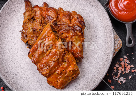 Delicious juicy grilled ribs with honey and mustard sauce with salt, spices and herbs 117691235