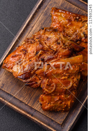 Delicious juicy grilled ribs with honey and mustard sauce with salt, spices and herbs 117691245