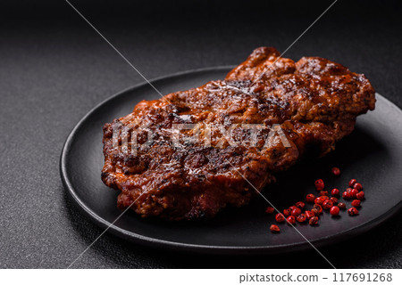 Fresh juicy delicious beef steak on a dark background 117691268