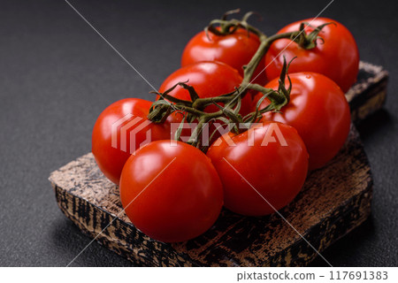 Juicy ripe red cherry tomatoes on a branch 117691383