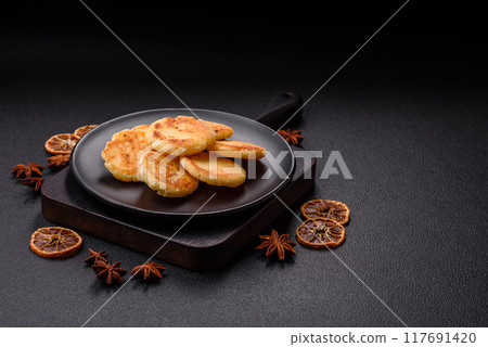 Delicious fresh sweet cheese pancakes with raisins and cinnamon 117691420