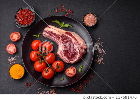 Fresh, raw beef steak with salt, spices and herbs Fresh, raw beef steak with salt, spices and herbs 117691476