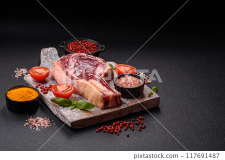 Fresh, raw beef steak with salt, spices and herbs Fresh, raw beef steak with salt, spices and herbs 117691487
