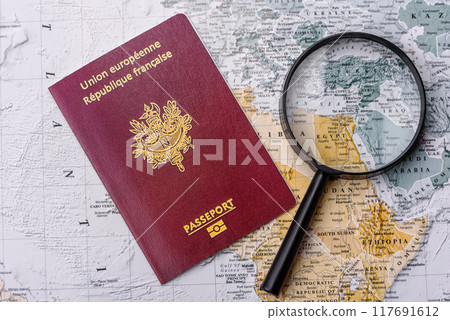Conceptual background for travel with passport, magnifying glass, world map and money Conceptual background for travel with passport, magnifying glass, world map and money 117691612