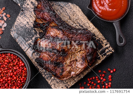 Juicy grilled beef tomahawk steak with salt, spices and herbs Juicy grilled beef tomahawk steak with salt, spices and herbs 117691754