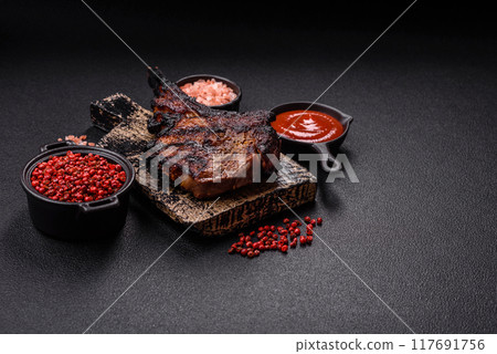 Juicy grilled beef tomahawk steak with salt, spices and herbs Juicy grilled beef tomahawk steak with salt, spices and herbs 117691756