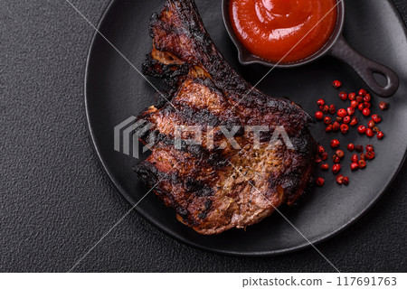 Juicy grilled beef tomahawk steak with salt, spices and herbs Juicy grilled beef tomahawk steak with salt, spices and herbs 117691763