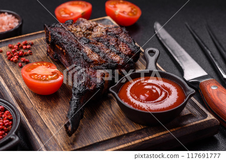 Juicy grilled beef tomahawk steak with salt, spices and herbs 117691777