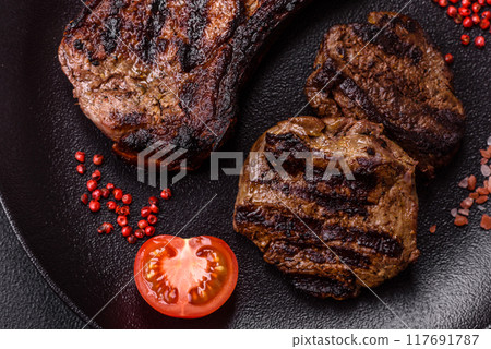 Juicy grilled beef tomahawk steak with salt, spices and herbs Juicy grilled beef tomahawk steak with salt, spices and herbs 117691787