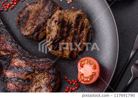 Juicy grilled beef tomahawk steak with salt, spices and herbs Juicy grilled beef tomahawk steak with salt, spices and herbs 117691790