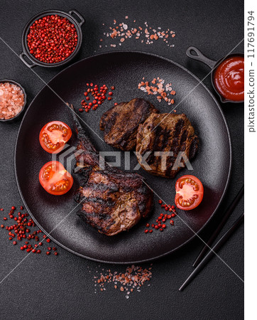 Juicy grilled beef tomahawk steak with salt, spices and herbs 117691794
