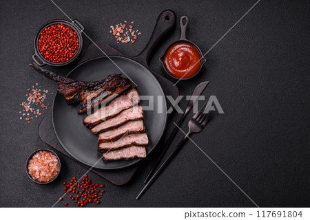 Juicy grilled beef tomahawk steak with salt, spices and herbs Juicy grilled beef tomahawk steak with salt, spices and herbs 117691804