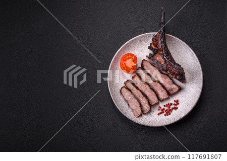 Juicy grilled beef tomahawk steak with salt, spices and herbs Juicy grilled beef tomahawk steak with salt, spices and herbs 117691807
