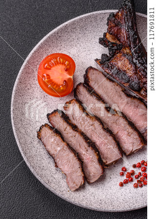 Juicy grilled beef tomahawk steak with salt, spices and herbs 117691811