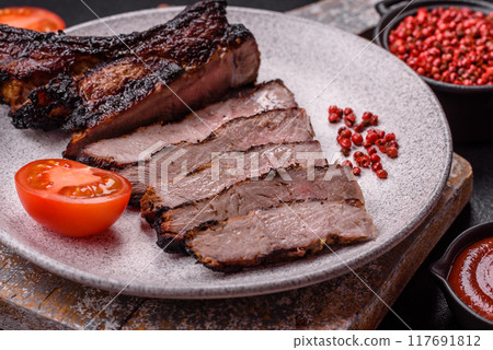Juicy grilled beef tomahawk steak with salt, spices and herbs 117691812