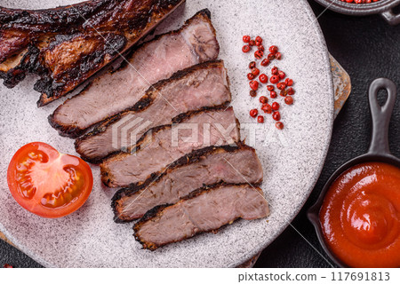 Juicy grilled beef tomahawk steak with salt, spices and herbs 117691813