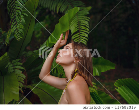 Portrait of a beautiful woman in tropical jungle Portrait of a beautiful woman in tropical jungle 117692019