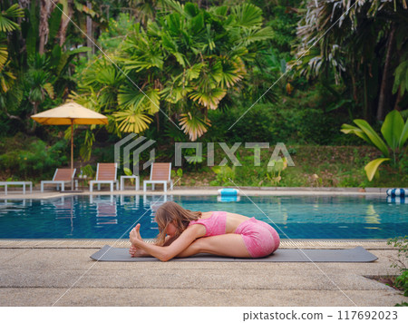 Beautiful woman practices yoga in Crabi, Thailand Beautiful woman practices yoga in Crabi, Thailand 117692023