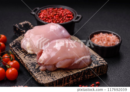 Fresh chicken fillet on a dark concrete table with spices and herbs 117692039