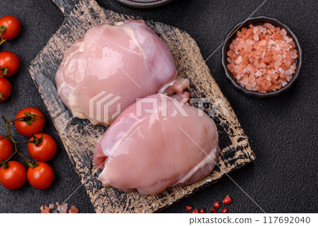 Fresh chicken fillet on a dark concrete table with spices and herbs 117692040