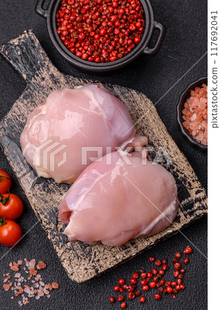 Fresh chicken fillet on a dark concrete table with spices and herbs 117692041