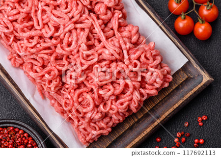 Fresh raw ground beef with salt and spices 117692113