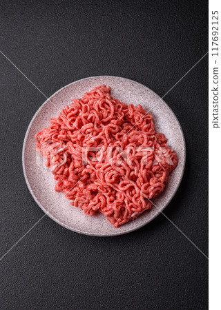 Fresh raw ground beef with salt and spices Fresh raw ground beef with salt and spices 117692125