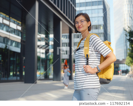 Asian woman over background of modern urban architecture in Vienna. 117692154