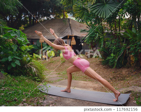 Beautiful woman practices yoga in Crabi, Thailand Beautiful woman practices yoga in Crabi, Thailand 117692156