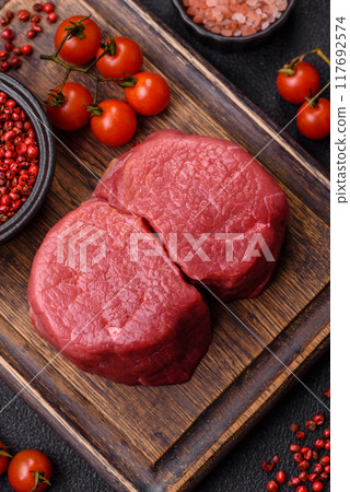 Fresh juicy raw beef medallions with salt and spices 117692574