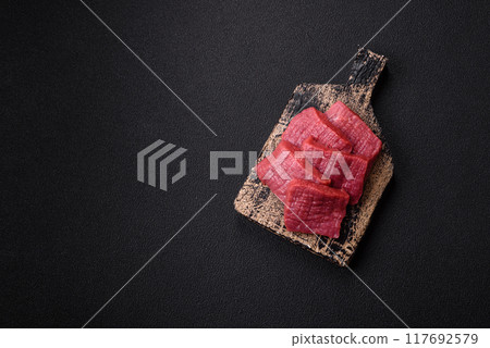 Juicy fresh raw beef meat with salt, spices and herbs Juicy fresh raw beef meat with salt, spices and herbs 117692579